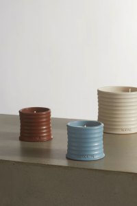 Loewe candles on a wooden surface