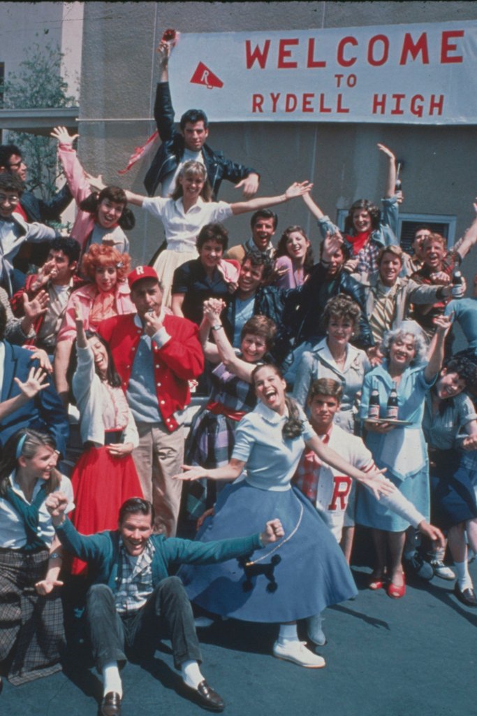 1978-Movie still from "Grease." Promotional group shot of the cast standing near high school entrance. (Photo by Bettmann/Corbis/Getty Images)