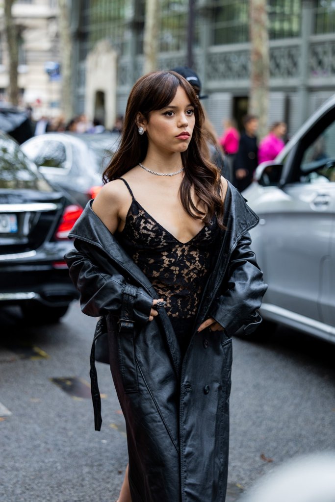 PARIS, FRANCE - OCTOBER 02: Jenna Ortega wears black laced dress, black coat outside Valentino during Paris Fashion Week - Womenswear Spring/Summer 2023 : Day Seven on October 02, 2022 in Paris, France. (Photo by Christian Vierig/Getty Images)